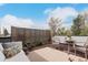 Charming patio featuring an outdoor seating area, a table with chairs, and a privacy screen at 3168 W 29Th Ave, Denver, CO 80211