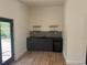 Bar area with dark cabinets, sink, wine fridge and floating shelves at 22 Rangeview Dr, Wheat Ridge, CO 80215