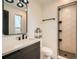 Well-lit bathroom featuring double sinks, modern fixtures, and a glass-enclosed shower at 22 Rangeview Dr, Wheat Ridge, CO 80215