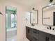 Elegant bathroom with double vanity, modern fixtures, and a tub shower at 22 Rangeview Dr, Wheat Ridge, CO 80215
