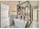 Stylish bathroom features a soaking tub, chandelier, and glass-enclosed shower with unique ceiling design at 22 Rangeview Dr, Wheat Ridge, CO 80215