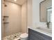 Stylish bathroom featuring modern fixtures, sleek vanity, and tiled walk-in shower at 22 Rangeview Dr, Wheat Ridge, CO 80215