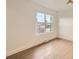 Bright bedroom featuring hardwood floors, a large window with views, and ample natural light at 22 Rangeview Dr, Wheat Ridge, CO 80215