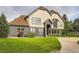 Charming two-story home featuring a well-manicured lawn, grey brick accents, and a welcoming front entrance at 22 Rangeview Dr, Wheat Ridge, CO 80215