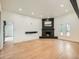 Living room with a black fireplace and mantel, hardwood floors, and bright natural light at 22 Rangeview Dr, Wheat Ridge, CO 80215
