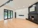 Spacious living room with a fireplace, hardwood floors, and doors leading to the patio at 22 Rangeview Dr, Wheat Ridge, CO 80215