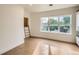 Open loft area with hardwood floors, large window, and ladder access at 22 Rangeview Dr, Wheat Ridge, CO 80215