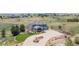 Aerial view of a home with a circular driveway, manicured lawn, and lush landscaping at 2339 Elkhorn St, Parker, CO 80138