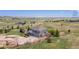High angle shot of two-story home with a three-car garage, stone accents, and lush landscaping in a rural setting at 2339 Elkhorn St, Parker, CO 80138