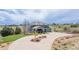 Aerial view of home featuring circular drive, well-maintained landscaping, and surrounding prairie at 2339 Elkhorn St, Parker, CO 80138