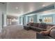 Large basement area with kitchenette, gray cabinets, stainless appliances, plus plush gray carpet, perfect for a media room at 2339 Elkhorn St, Parker, CO 80138