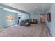 Spacious finished basement with light blue walls, gray carpet, and comfortable seating area, ideal for relaxing and entertaining at 2339 Elkhorn St, Parker, CO 80138