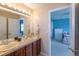 Bright bathroom with double sinks and a view into a blue bedroom at 2339 Elkhorn St, Parker, CO 80138