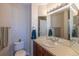 Neutral bathroom features a large mirror, vanity and commode at 2339 Elkhorn St, Parker, CO 80138