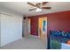 Red bedroom with a ceiling fan and a closet at 2339 Elkhorn St, Parker, CO 80138