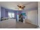 Bright purple bedroom with a fan, a large window, and a working space at 2339 Elkhorn St, Parker, CO 80138