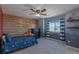 Bedroom featuring a ceiling fan, an accent wall, and a bright window at 2339 Elkhorn St, Parker, CO 80138