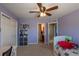 Purple bedroom with ceiling fan, a storage closet, and attached bathroom at 2339 Elkhorn St, Parker, CO 80138