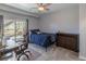 Bedroom featuring gray walls, ceiling fan, and sliding glass doors to patio at 2339 Elkhorn St, Parker, CO 80138