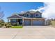 Charming two-story home with stone accents, gray siding, and a spacious two-car garage at 2339 Elkhorn St, Parker, CO 80138