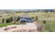 Expansive two-story home with a three-car garage, stone accents, and lush landscaping in a rural setting at 2339 Elkhorn St, Parker, CO 80138