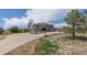 Two-story home featuring stone accents, a covered porch, a spacious three-car garage and long driveway at 2339 Elkhorn St, Parker, CO 80138