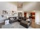 Bright living room featuring tall ceilings, large sectional couch, an open concept, and adjacent kitchen at 2339 Elkhorn St, Parker, CO 80138