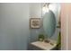 Quaint powder room features updated vanity, mirror, and fixtures, offering a stylish and convenient space at 2339 Elkhorn St, Parker, CO 80138