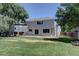 A spacious backyard with lush green grass and a small patio perfect for entertaining at 13382 Franklin St, Thornton, CO 80241