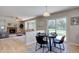 Bright dining area featuring a modern table set, hardwood floors, and sliding glass doors to the backyard at 13382 Franklin St, Thornton, CO 80241