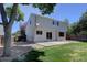 Home's exterior featuring a patio, well-maintained lawn, and mature shade trees at 13382 Franklin St, Thornton, CO 80241