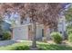 Inviting two-story home with brick accents, complemented by lush greenery and a mature tree at 13382 Franklin St, Thornton, CO 80241