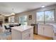 Open kitchen with stainless steel appliances, center island, and adjacent dining area with backyard views at 13382 Franklin St, Thornton, CO 80241