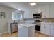 Bright kitchen featuring a center island, stainless steel appliances and white cabinets at 13382 Franklin St, Thornton, CO 80241