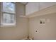 Clean laundry room with a window, white cabinets for storage, and functional utility connections at 13382 Franklin St, Thornton, CO 80241