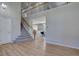 Spacious living area with hardwood floors and staircase leading to an upstairs balcony at 13382 Franklin St, Thornton, CO 80241