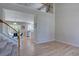 Open-concept living area with hardwood floors and staircase leading to an upstairs balcony at 13382 Franklin St, Thornton, CO 80241