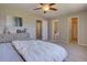 Spacious main bedroom with a ceiling fan, complemented by neutral walls and plush carpet flooring at 13382 Franklin St, Thornton, CO 80241