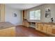 Spacious office area with wooden built-in desk and storage cabinets, bathed in natural light at 13382 Franklin St, Thornton, CO 80241
