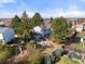 Expansive backyard featuring mature trees, garden beds, and plenty of space for outdoor activities and entertaining at 1024 S Mobile St, Aurora, CO 80017