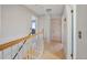 Hallway with wooden floors, closet, and staircase at 1024 S Mobile St, Aurora, CO 80017