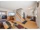 Open-concept living area flows to dining space and features hardwood floors and bright natural light at 1024 S Mobile St, Aurora, CO 80017