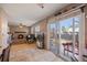 Cozy living area with fireplace, tile floors, and sliding glass doors opening to the backyard at 1024 S Mobile St, Aurora, CO 80017