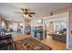 Open living space with hardwood floors, multiple seating areas, and seamless transition to the kitchen at 1024 S Mobile St, Aurora, CO 80017