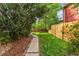 Backyard with garden, grass, stone walkway, and wooden fence at 3321 W 29Th Ave, Denver, CO 80211