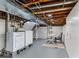 Partially finished basement with laundry area, painted walls, and flex space at 3321 W 29Th Ave, Denver, CO 80211