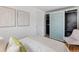 Bright bedroom featuring modern closet with sliding doors, neutral walls, and hardwood floors at 3321 W 29Th Ave, Denver, CO 80211