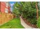 Beautiful front yard with a lush green lawn and mature trees leading to the home's entrance at 3321 W 29Th Ave, Denver, CO 80211