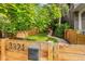 Home exterior with address on a wood fence, garden, and a walkway at 3321 W 29Th Ave, Denver, CO 80211