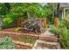 Landscaped front yard with stone retaining wall and lush plantings at 3321 W 29Th Ave, Denver, CO 80211